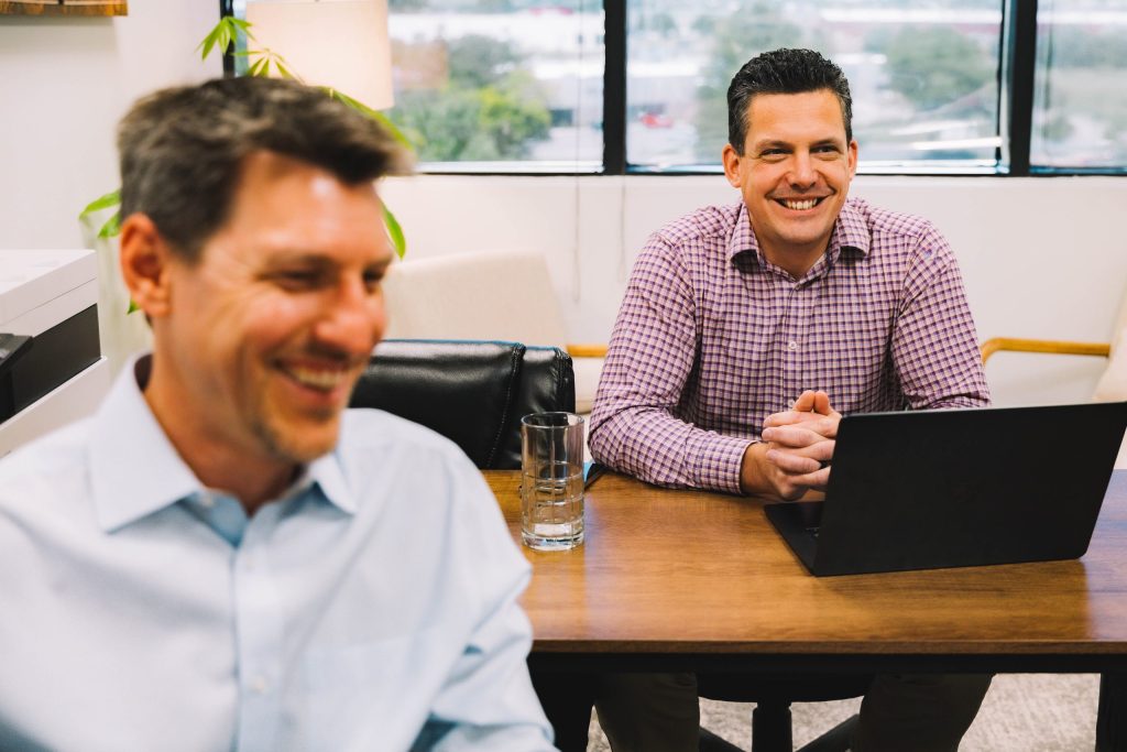 2 coworkers in Colorado working and smiling